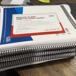 a photo of a stack of 7 spiral-bound workbooks